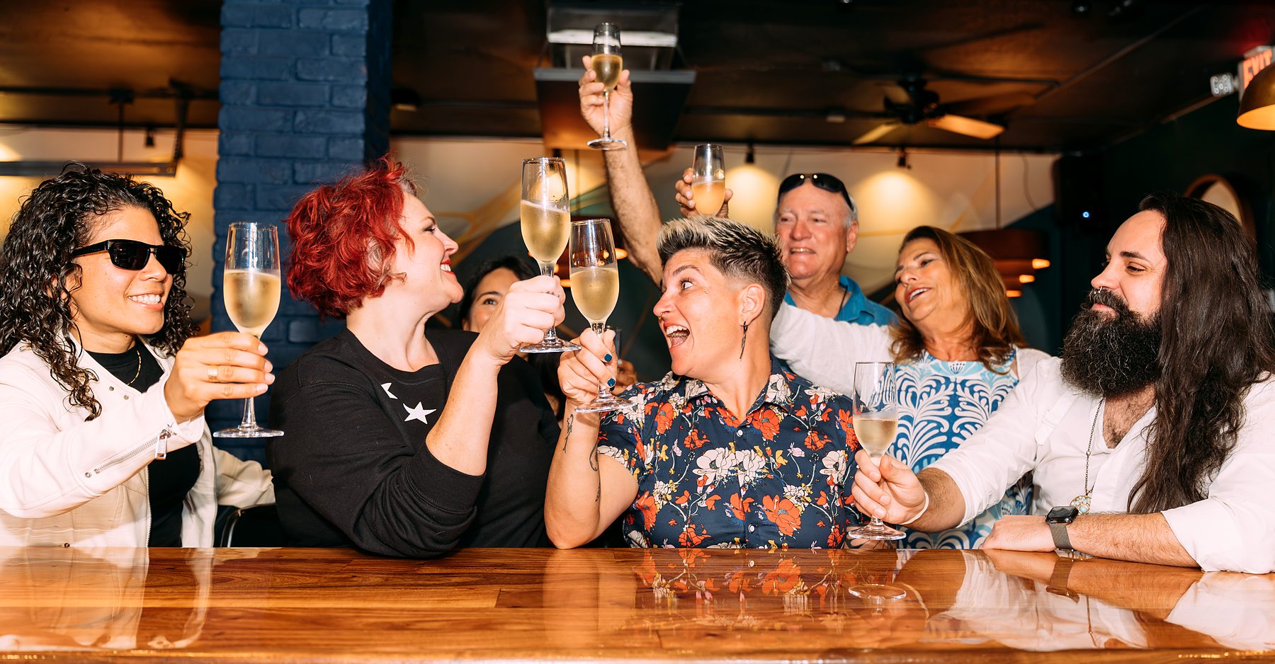 Friends toasting with champagne at a private celebration, event photography in South Florida