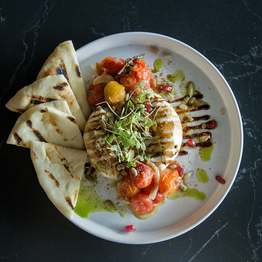 Burrata with roasted cherry tomatoes and micro herbs, restaurant food photography in Fort Lauderdale
