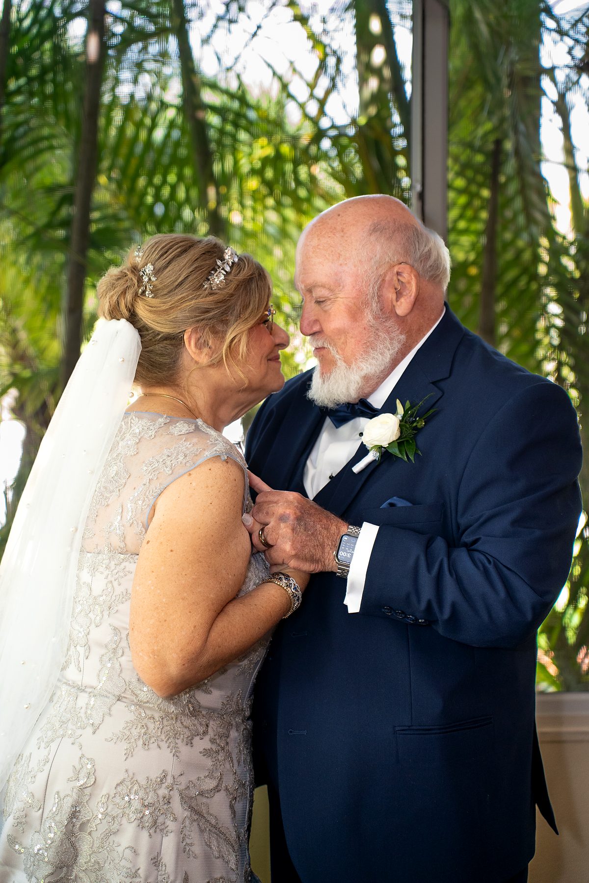 Wedding couple sharing a quiet moment among palm trees, Fort Lauderdale wedding photography